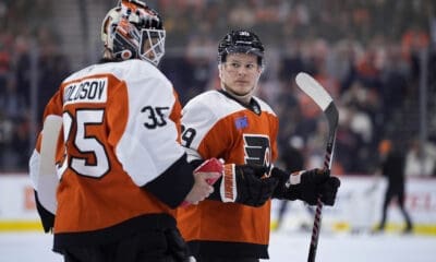 Philadelphia Flyers goalie Aleksei Kolosov on the ice with Matvei Michkov