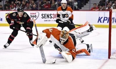 Philadelphia Flyers goalie Ivan Fedotov dives to his left to make a save against the Ottawa Senators.