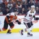 Philadelphia Flyers forward Matvei Michkov pursues Chicago Blackhawks forward Connor Bedard