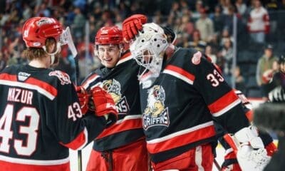 Carter Mazur (43) and Sebastian Cossa (33) celebrate after a Griffins win.