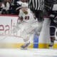 Chicago Blackhawks center Philipp Kurashev, left, collects the puck as Colorado Avalanche center Ross Colton pursues in the second period of an NHL hockey game Monday, Oct. 28, 2024, in Denver. (AP Photo/David Zalubowski)