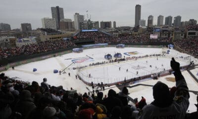 Fans cheer during the first period of the NHL Winter Classic hockey game between the Detroit Red Wings and the Chicago Blackhawks at Wrigley Field in Chicago, Jan. 1, 2009. (AP Photo/M. Spencer Green, File)