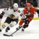 Chicago Blackhawks left wing Tyler Bertuzzi, left, takes the puck as Anaheim Ducks defenseman Jackson LaCombe reaches in during the second period of an NHL hockey game, Sunday, Nov. 3, 2024, in Anaheim, Calif. (AP Photo/Mark J. Terrill)