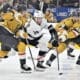 Los Angeles Kings right wing Alex Laferriere (14) skates between Vegas Golden Knights center Brett Howden (21) and center Tomas Hertl (48) during the first period of an NHL hockey game Tuesday, Oct. 22, 2024, in Las Vegas. (AP Photo/David Becker)