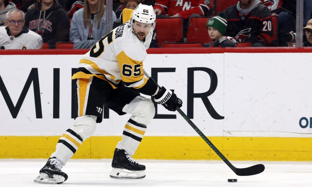 Pittsburgh Penguins' Erik Karlsson (65) moves the puck against the Carolina Hurricanes during the second period of an NHL hockey game in Raleigh, N.C., Sunday, Jan. 5, 2025. (AP Photo/Karl DeBlaker)