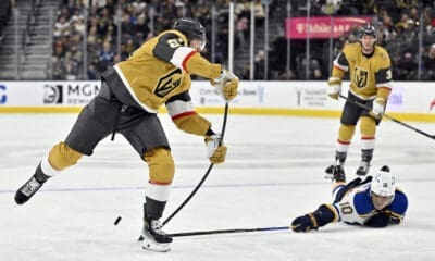 St. Louis Blues center Brayden Schenn (10) breaks up a shot by Vegas Golden Knights defenseman Shea Theodore, left, during the second period of an NHL hockey game Monday, Jan. 20, 2025, in Las Vegas. (AP Photo/David Becker)