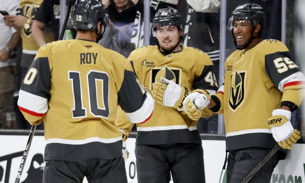Vegas Golden Knights centers Nicolas Roy (10) and Ivan Barbashev (49) celebrate with right wing Keegan Kolesar (55) after Kolesar's goal during the second period of an NHL hockey game against the Chicago Blackhawks Thursday, Feb. 27, 2025, in Las Vegas. (AP Photo/Ian Maule)