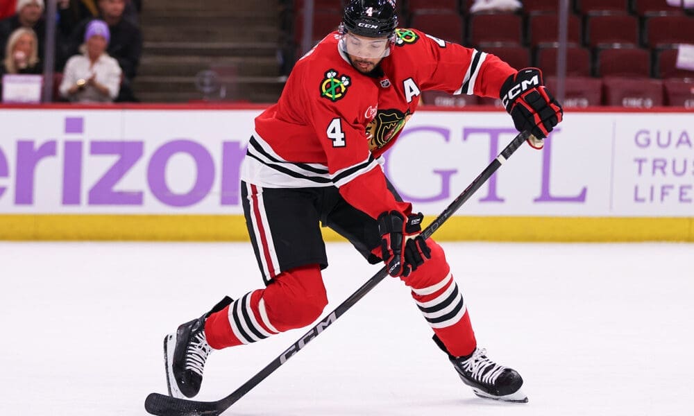 CHICAGO, IL - JANUARY 26: Seth Jones #4 of the Chicago Blackhawks controls the puck during the third period against the Minnesota Wild on January 26, 2025 at the United Center in Chicago, Illinois. (Photo by Melissa Tamez/Icon Sportswire)