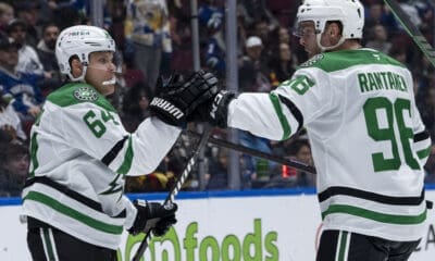 Dallas Stars' Mikael Granlund (64) and Mikko Rantanen (96) celebrate Granlund's goal against the Vancouver Canucks during the second period of an NHL hockey game in Vancouver, British Columbia, Sunday, March 9, 2025. (Ethan Cairns/The Canadian Press via AP)