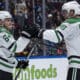 Dallas Stars' Mikael Granlund (64) and Mikko Rantanen (96) celebrate Granlund's goal against the Vancouver Canucks during the second period of an NHL hockey game in Vancouver, British Columbia, Sunday, March 9, 2025. (Ethan Cairns/The Canadian Press via AP)