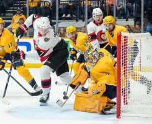 Brady Tkachuk, left, attempts a backhand shot against Juuse Saros. Photo by John Russell/Nashville Predators