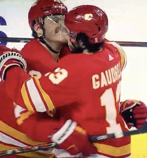 Calgary Flames' Martthew Tkachuk and Johnny Gaudreau celebrate Tkachuk's second of three goals against Seattle Kraken on April 12,2022. It was Johnny Gaudreau's 100th point of the season as he earned an assist on the play.