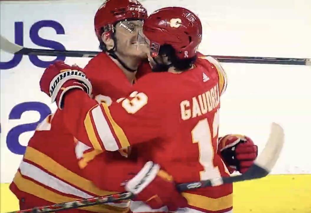 Calgary Flames' Martthew Tkachuk and Johnny Gaudreau celebrate Tkachuk's second of three goals against Seattle Kraken on April 12,2022. It was Johnny Gaudreau's 100th point of the season as he earned an assist on the play.