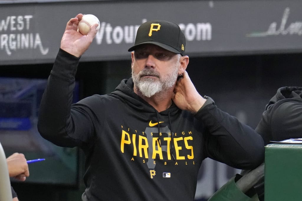 Pittsburgh Pirates manager Derek Shelton tosses a foul ball to a fan during the first inning of the team's baseball game against the Washington Nationals in Pittsburgh, Wednesday, Sept. 13, 2023. (AP Photo/Gene J. Puskar)