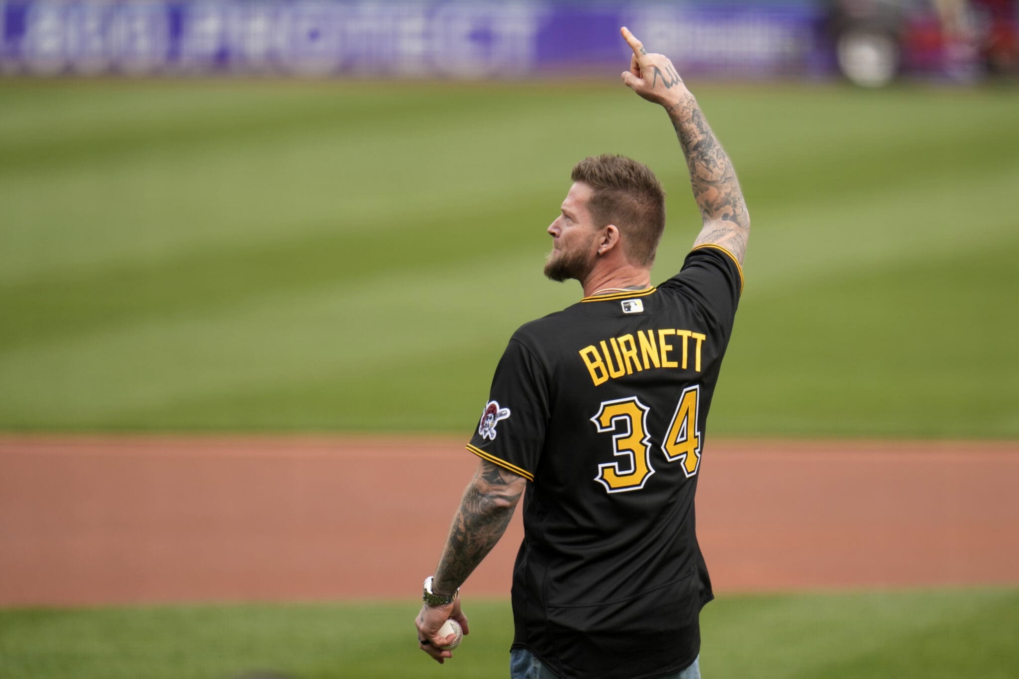 Former Pittsburgh Pirates pitcher A.J. Burnett waves to fans at PNC Park before throwing a ceremonial first pitch before the Pirates home opener baseball game against the Chicago White Sox in Pittsburgh, Friday, April 7, 2023. (AP Photo/Gene J. Puskar)
