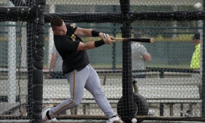 Pittsburgh Pirates catcher Henry Davis hits in the batting cage during a baseball spring training workout Saturday, Feb. 17, 2024, in Bradenton, Fla. (AP Photo/Charlie Neibergall)