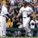 Pittsburgh Pirates' Joey Bart, right, is greeted by third base coach Mike Rabelo, left, after hitting a home run during the second inning of a baseball game against the Baltimore Orioles, Saturday, April 6, 2024, in Pittsburgh. (AP Photo/Matt Freed)