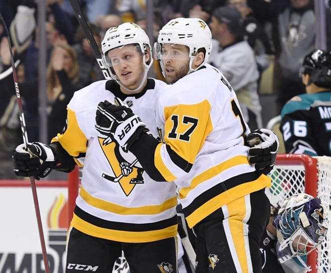 PITTSBURGH, PA - DECEMBER 17: Pittsburgh Penguins Right Wing Bryan Rust (17) celebrates his goal with Pittsburgh Penguins Right Wing Jake Guentzel (59) during the first period in the NHL game between the Pittsburgh Penguins and the Anaheim Ducks on December 17, 2018, at PPG Paints Arena in Pittsburgh, PA. (Photo by Jeanine Leech/Icon Sportswire)