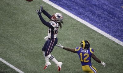 New England Patriots' Stephon Gilmore (24) prepares to intercept the ball against Los Angeles Rams' Brandin Cooks (12) during the second half of the NFL Super Bowl 53 football game Sunday, Feb. 3, 2019, in Atlanta. (AP Photo/Charlie Riedel)
