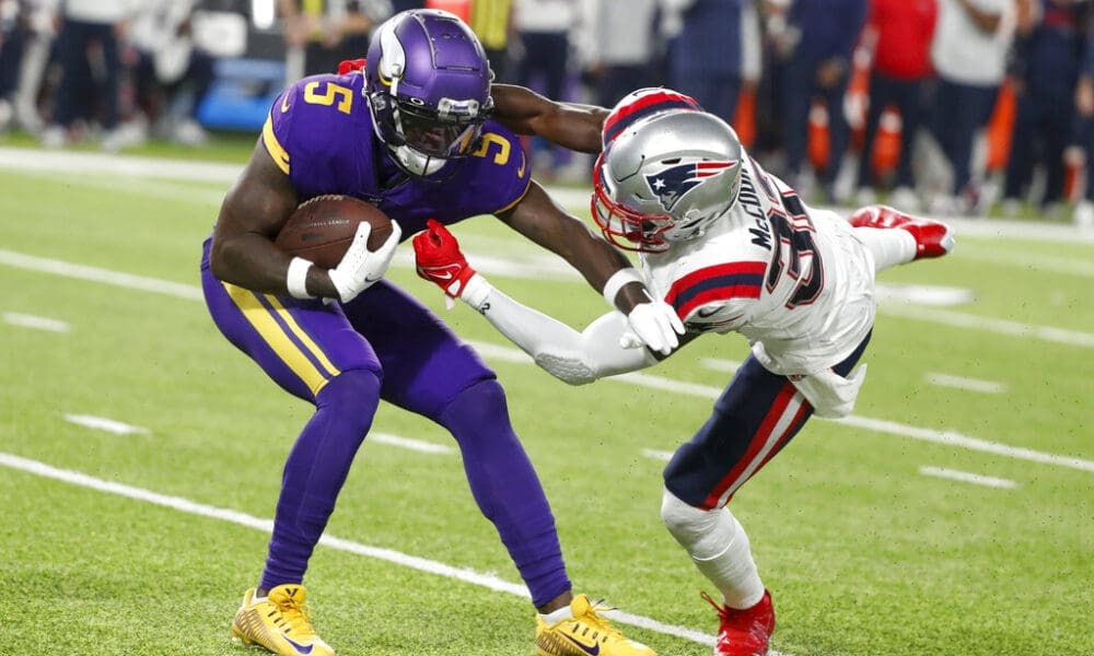 Minnesota Vikings wide receiver Jalen Reagor gets taken down by the New England Patriots defender
