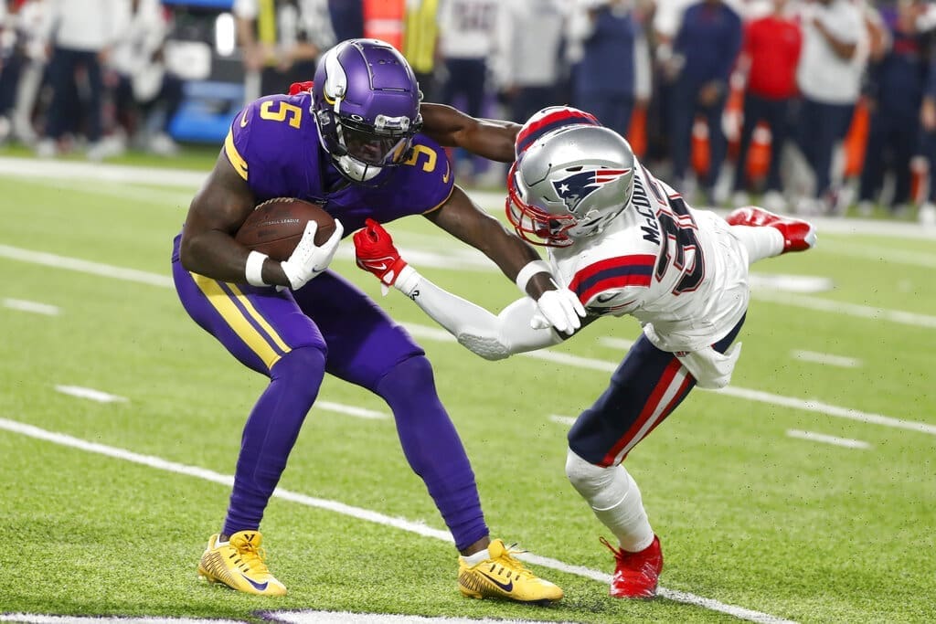 Minnesota Vikings wide receiver Jalen Reagor gets taken down by the New England Patriots defender