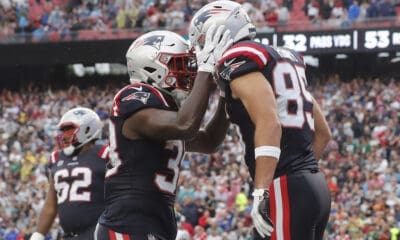 Hunter Henry of the New England Patriots celebrates his Week 1 touchdown with teammate Rhamondre Stevenson.