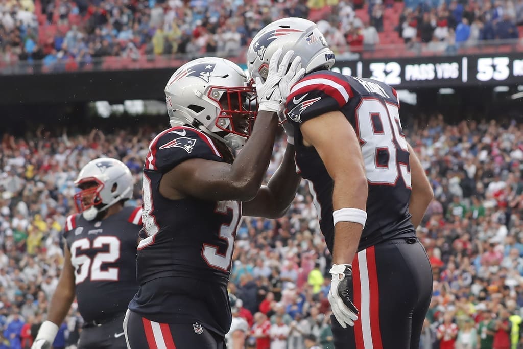 Hunter Henry of the New England Patriots celebrates his Week 1 touchdown with teammate Rhamondre Stevenson.