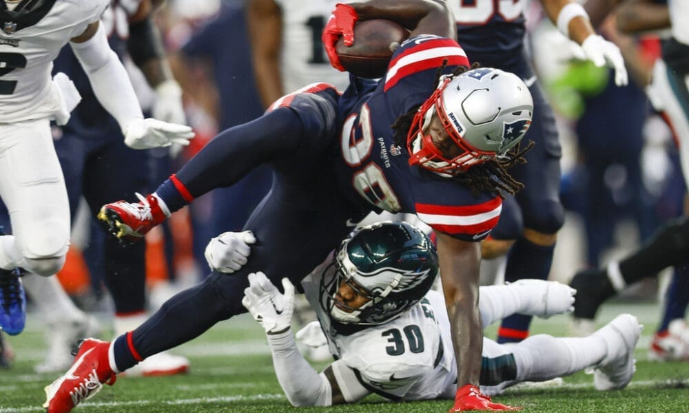 New England Patriots running back Rhamondre Stevenson (38) is tackled by Philadelphia Eagles safety Justin Evans (30)during the second half of an NFL football game, Sunday, Sept. 10, 2023, in Foxborough, Mass. (AP Photo/Greg M. Cooper)