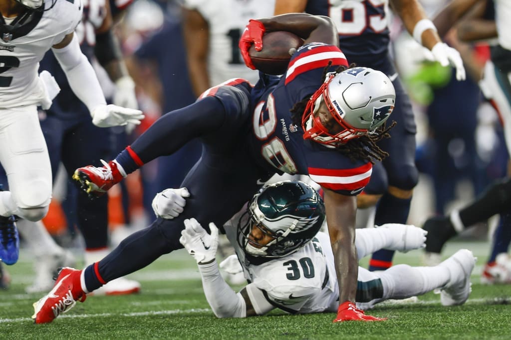 New England Patriots running back Rhamondre Stevenson (38) is tackled by Philadelphia Eagles safety Justin Evans (30)during the second half of an NFL football game, Sunday, Sept. 10, 2023, in Foxborough, Mass. (AP Photo/Greg M. Cooper)