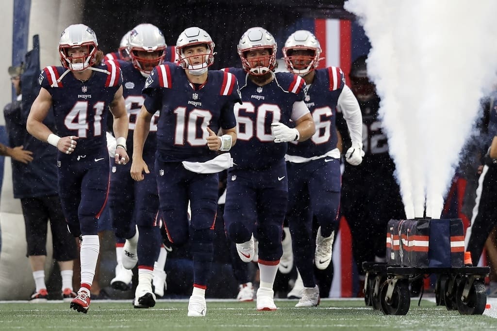 New England Patriots are led out by captains Mac Jones and David Andrews to take the field for their Week 1 game against the Philadelphia Eagles.