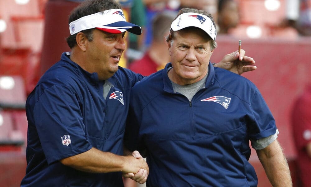New England Patriots assistant coach Michael Lombardi. left, shakes hands with oach Bill Belichick before an NFL football preseason game against the Washington Redskins in Landover, Md., Thursday, Aug. 7, 2014. (AP Photo/Alex Brandon)