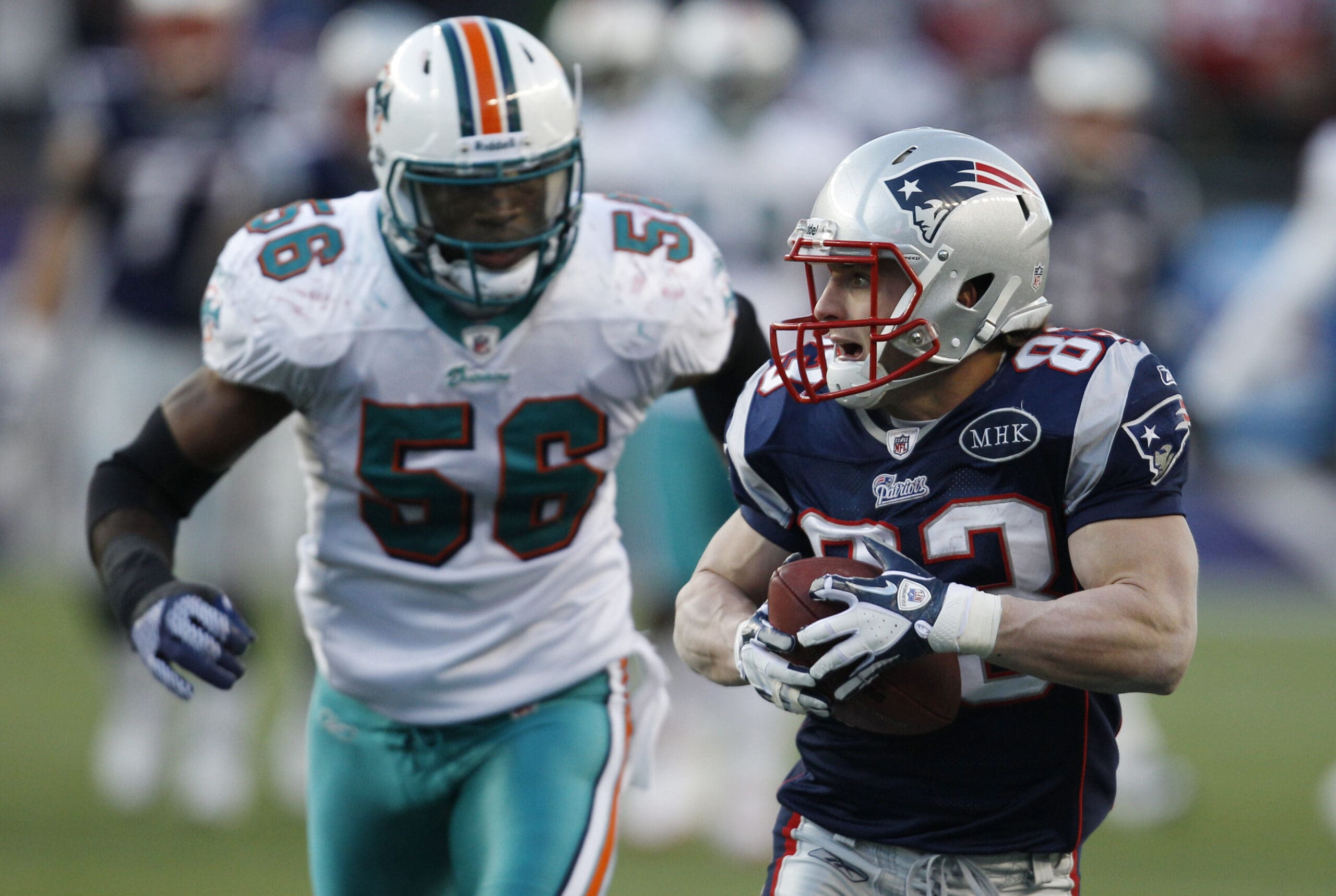 New England Patriots WR Wes Welker runs away from the Miami Dolphins defender