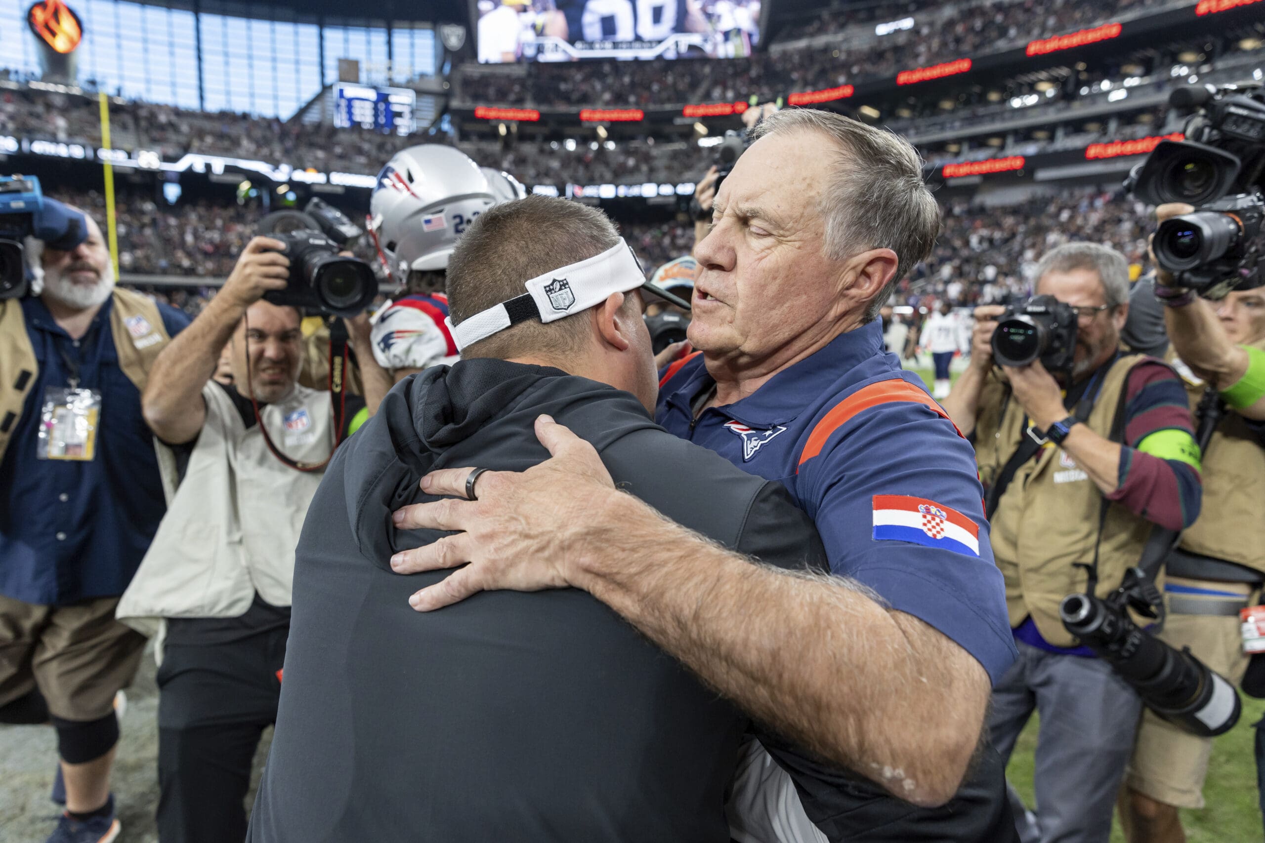 Postgame embrace between New England Patriots head coach Bill Belichick and Las Vegas Raiders head coach Josh McDaniels