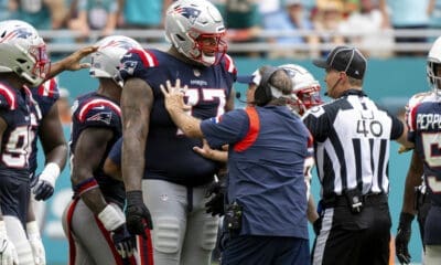 New England Patriots head coach Bill Belichick holds back New England Patriots offensive lineman Trent Brown (77) from joining a scuffle between players on the field during an NFL football game against the Miami Dolphins, Sunday, Oct. 29, 2023, in Miami Gardens, Fla. (AP Photo/Doug Murray)