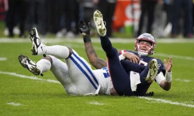 New England Patriots quarterback Mac Jones (10) is sacked by Indianapolis Colts defensive end Tyquan Lewis (94) during an NFL football game at Deutsche Bank Park Stadium in Frankfurt, Germany, Sunday, Nov. 12, 2023. (AP Photo/Doug Benc)