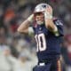 New England Patriots quarterback Mac Jones (10) reacts after throwing an interception during an NFL football game between the New England Patriots and the Indianapolis Colts at Deutsche Bank Park Stadium in Frankfurt, Germany, Sunday, Nov. 12, 2023. (AP Photo/Steve Luciano)