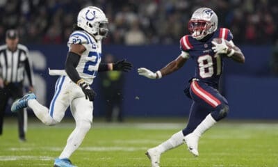 New England Patriots wide receiver Demario Douglas (81) runs the ball while Indianapolis Colts cornerback Kenny Moore II (23) chases during an NFL football game between the New England Patriots and the Indianapolis Colts at Deutsche Bank Park Stadium in Frankfurt, Germany, Sunday, Nov. 12, 2023. (AP Photo/Steve Luciano)