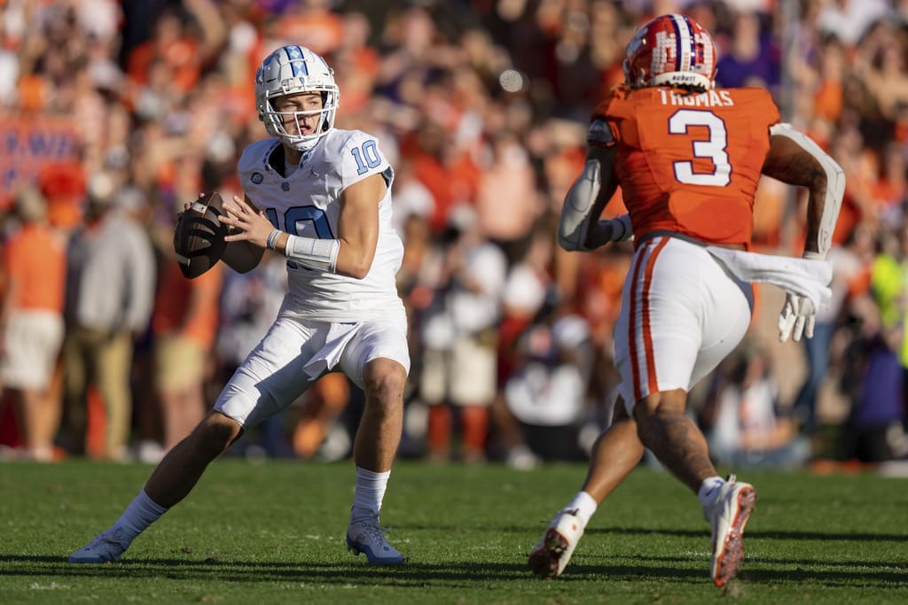 Clemson defensive end Xavier Thomas (3) pressures North Carolina quarterback Drake Maye (10) during the first half of an NCAA college football game Saturday, Nov. 18, 2023, in Clemson, S.C. Maye is among the quarterbacks being considered by the New England Patriots in the 2024 NFL Draft (AP Photo/Jacob Kupferman)