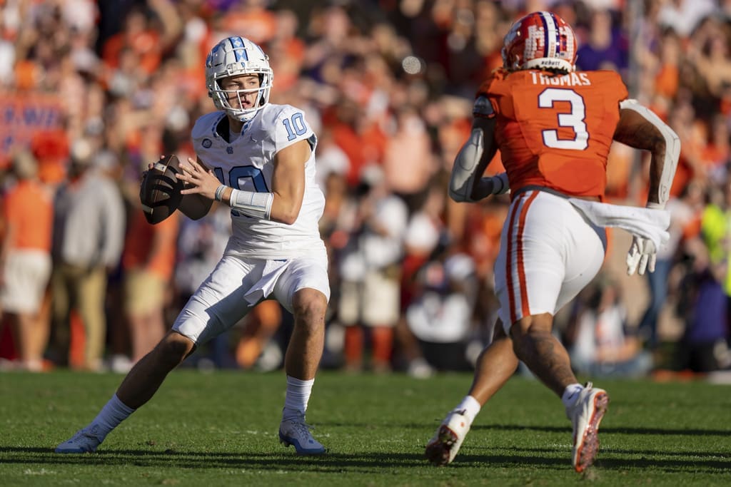 Clemson defensive end Xavier Thomas (3) pressures North Carolina quarterback Drake Maye (10), a New England Patriots draft target, during the first half of an NCAA college football game Saturday, Nov. 18, 2023, in Clemson, S.C. Maye is among the quarterbacks being considered by the New England Patriots in the 2024 NFL Draft (AP Photo/Jacob Kupferman)