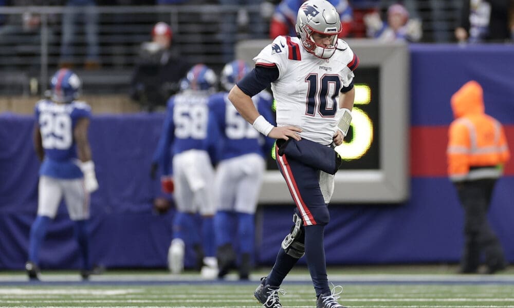 New England Patriots quarterback Mac Jones (10) walks off the field after throwing an interception against the New York Giants during the second quarter of an NFL football game, Sunday, Nov. 26, 2023, in East Rutherford, N.J. (AP Photo/Adam Hunger)