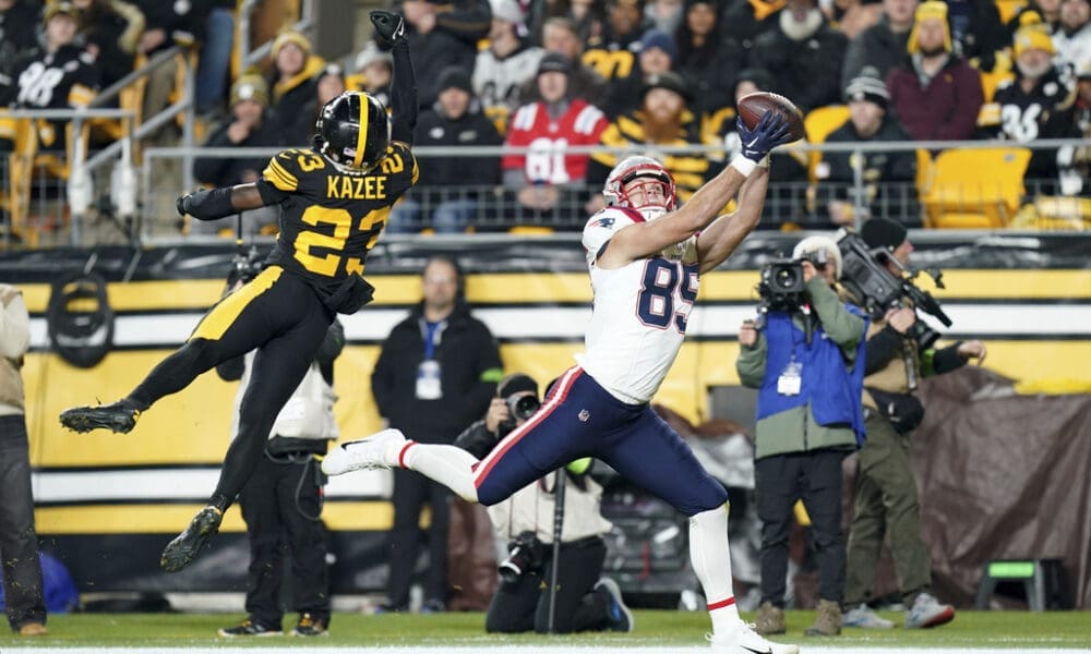New England Patriots tight end Hunter Henry (85) catches a touchdown pass as Pittsburgh Steelers safety Damontae Kazee (23) defends during the first half of an NFL football game on Thursday, Dec. 7, 2023, in Pittsburgh. (AP Photo/Matt Freed)