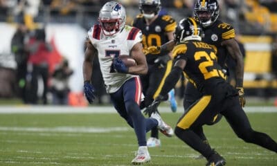 New England Patriots wide receiver JuJu Smith-Schuster (7) runs with the ball past Pittsburgh Steelers safety Damontae Kazee (23) during the first half of an NFL football game on Thursday, Dec. 7, 2023, in Pittsburgh. He was the Patriots highest graded offensive player by Pro Football Focus in Week 14 (AP Photo/Gene J. Puskar)