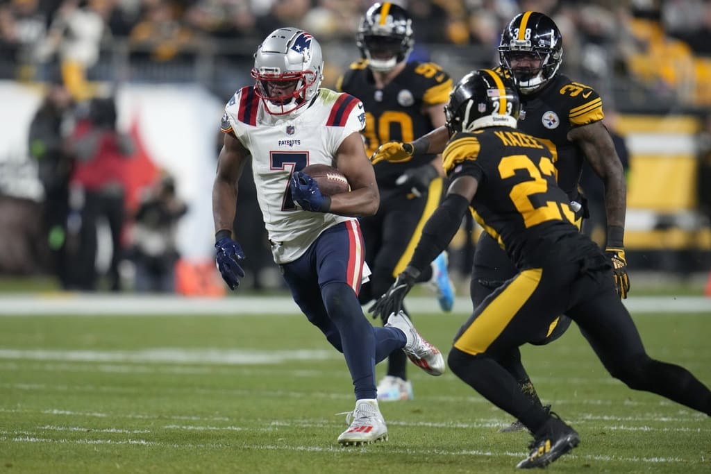 New England Patriots wide receiver JuJu Smith-Schuster (7) runs with the ball past Pittsburgh Steelers safety Damontae Kazee (23) during the first half of an NFL football game on Thursday, Dec. 7, 2023, in Pittsburgh. He was the Patriots highest graded offensive player by Pro Football Focus in Week 14 (AP Photo/Gene J. Puskar)