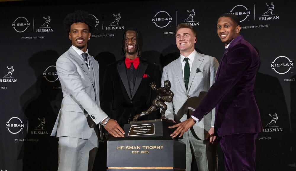 Heisman Trophy finalists, from left, LSU quarterback Jayden Daniels, Ohio State wide receiver Marvin Harrison Jr., Oregon quarterback Bo Nix and Washington quarterback Michael Penix Jr. pose with the trophy after attending a news conference before the award ceremony, Saturday, Dec. 9, 2023, in New York. One of them could be on the New England Patriots in 2024. All four are going in Round 1 of the latest mock 2024 NFL Draft. (AP Photo/Eduardo Munoz Alvarez)