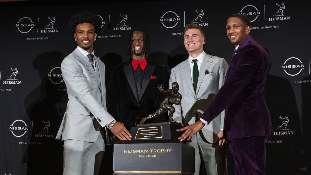 Heisman Trophy finalists, from left, LSU quarterback Jayden Daniels, Ohio State wide receiver Marvin Harrison Jr., Oregon quarterback Bo Nix and Washington quarterback Michael Penix Jr. pose with the trophy after attending a news conference before the award ceremony, Saturday, Dec. 9, 2023, in New York. One of them could be on the New England Patriots in 2024. All four are going in Round 1 of the latest mock 2024 NFL Draft. (AP Photo/Eduardo Munoz Alvarez)