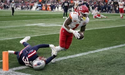 Kansas City Chiefs running back Jerick McKinnon (1) enters the end zone for a touchdown as New England Patriots linebacker Marte Mapu (30) tries to defend during the first half of an NFL football game, Sunday, Dec. 17, 2023, in Foxborough, Mass. (AP Photo/Charles Krupa)