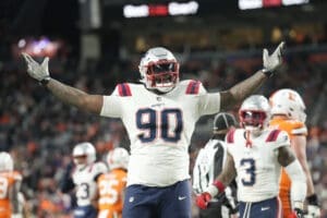 New England Patriots defensive tackle Christian Barmore (90) reacts after a play during the second half of an NFL football game against the Denver Broncos, Sunday, Dec. 24, 2023, in Denver. (AP Photo/David Zalubowski)