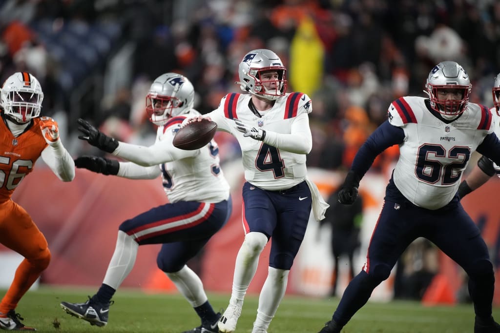 New England Patriots quarterback Bailey Zappe (4) in the first half of an NFL football game in Empower Field at Mile High Sunday, Dec. 24, 2023, in Denver. (AP Photo/David Zalubowski)