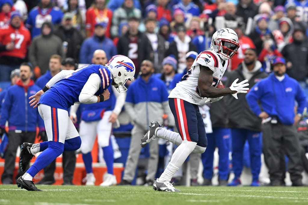 New England Patriots Jalen Reagor, right, gets past Buffalo Bills place kicker Tyler Bass (2) on a 98-yard kickoff return for a touchdown during the first half of an NFL football game in Orchard Park, N.Y., Sunday, Dec. 31, 2023. (AP Photo/Adrian Kraus)
