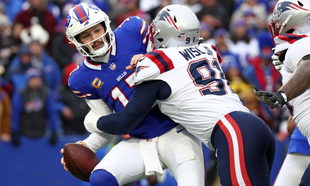 Buffalo Bills quarterback Josh Allen, left, is sacked by New England Patriots defensive end Deatrich Wise Jr. (91) during the first half of an NFL football game in Orchard Park, N.Y., Sunday, Dec. 31, 2023. Wise was the highest ranked PFF player for the Patriots in the game. (AP Photo/Jeffrey T. Barnes )